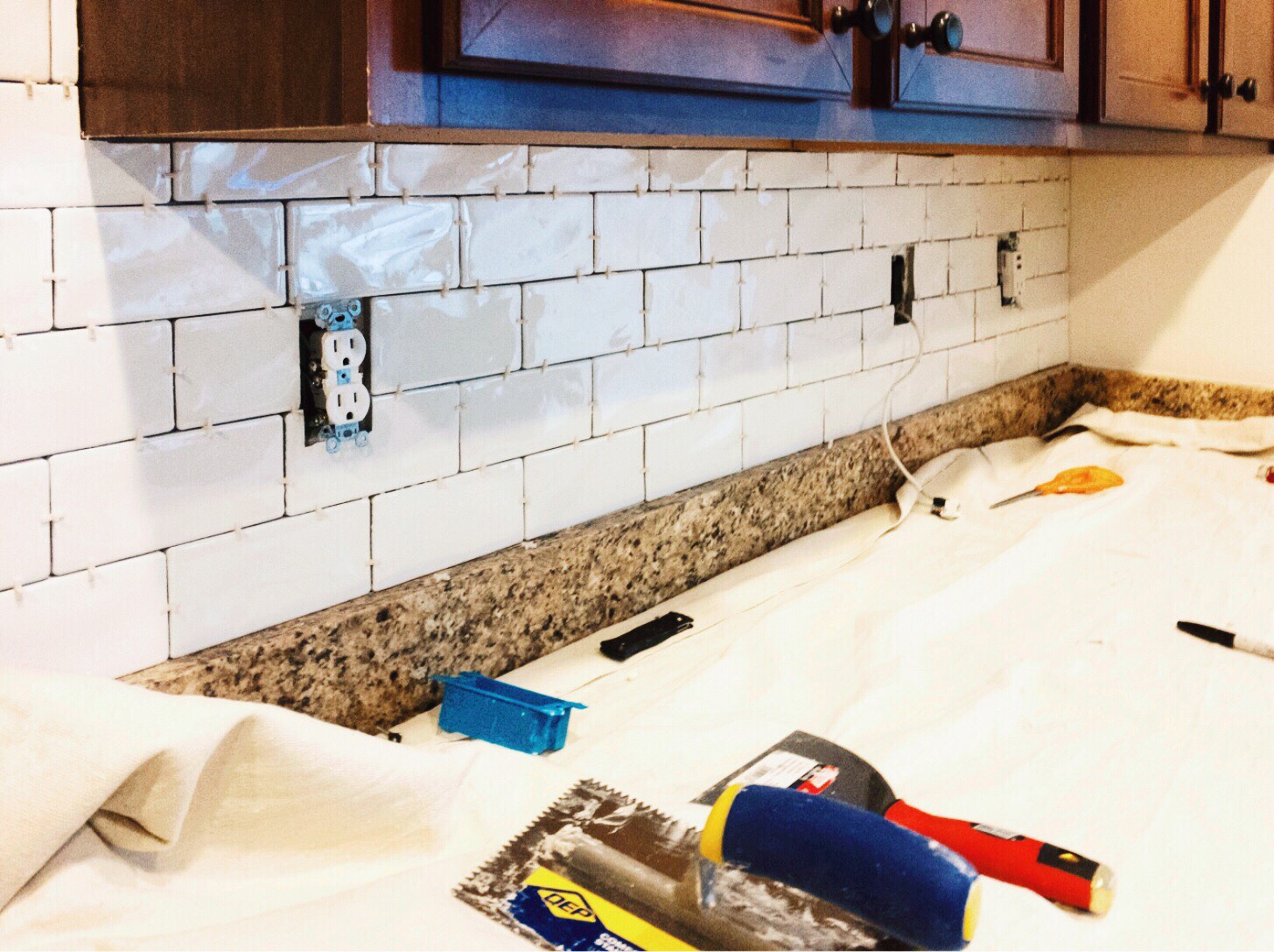 kitchen back splash being updated with white subway tiles. 5 ways to increase your homes value